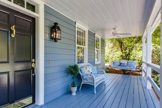 A painted porch and deck on the front of a house.